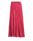 The Maribel Bias Skirt w/ Slit by Nation LTD is a long, flowing silk skirt in vibrant pink with a subtle sheen and a bias cut design. It features an elastic high waist and a slight flare at the bottom, giving it a smooth, seamless appearance that effortlessly enhances its graceful silhouette.