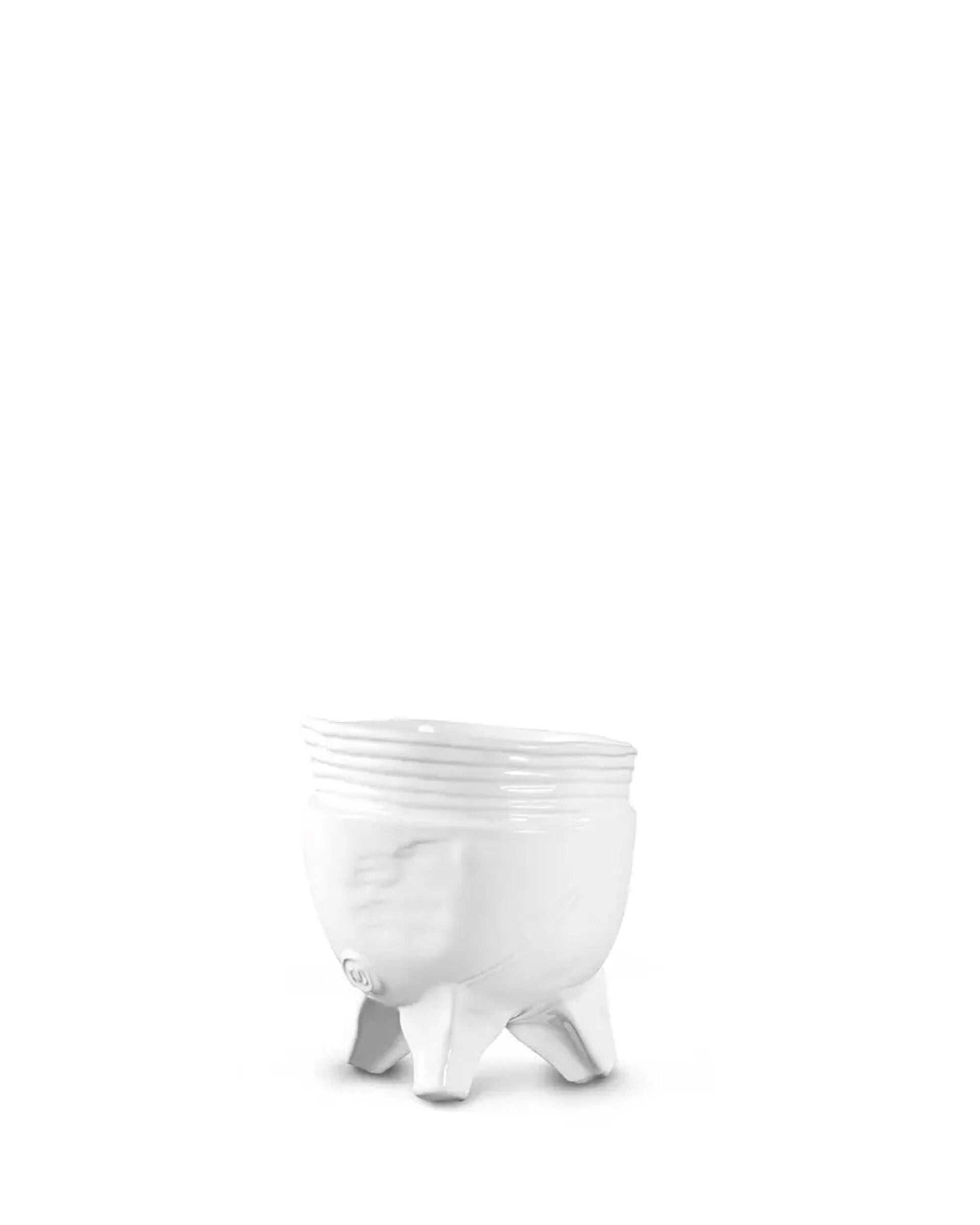 The Montes Doggett Footed Bowl No 273 is a small, white ceramic bowl with three short legs, a slightly textured surface, and minimalist design. Microwave safe for everyday use. Set against a plain white background.
