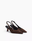 The Rag & Bone madison slingback heel is a women's leopard-print shoe with a pointed toe, low kitten heel, and an ankle strap with a small buckle for added style.