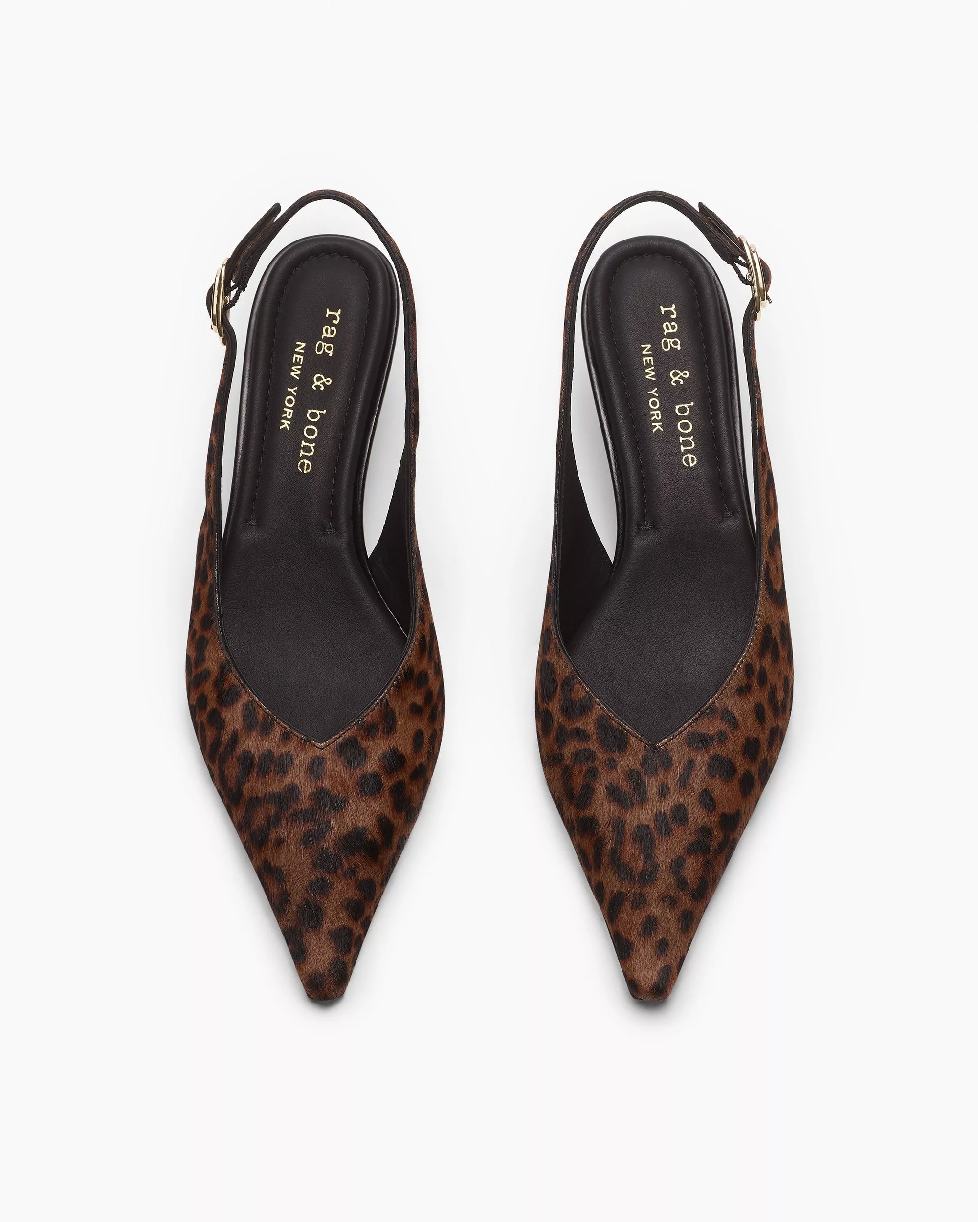 A pair of Rag & Bone madison slingback heels featuring pointed toes, leopard print, black OrthoLite foam insoles labeled "Rag & Bone New York," and gold buckle ankle straps, shown from above.
