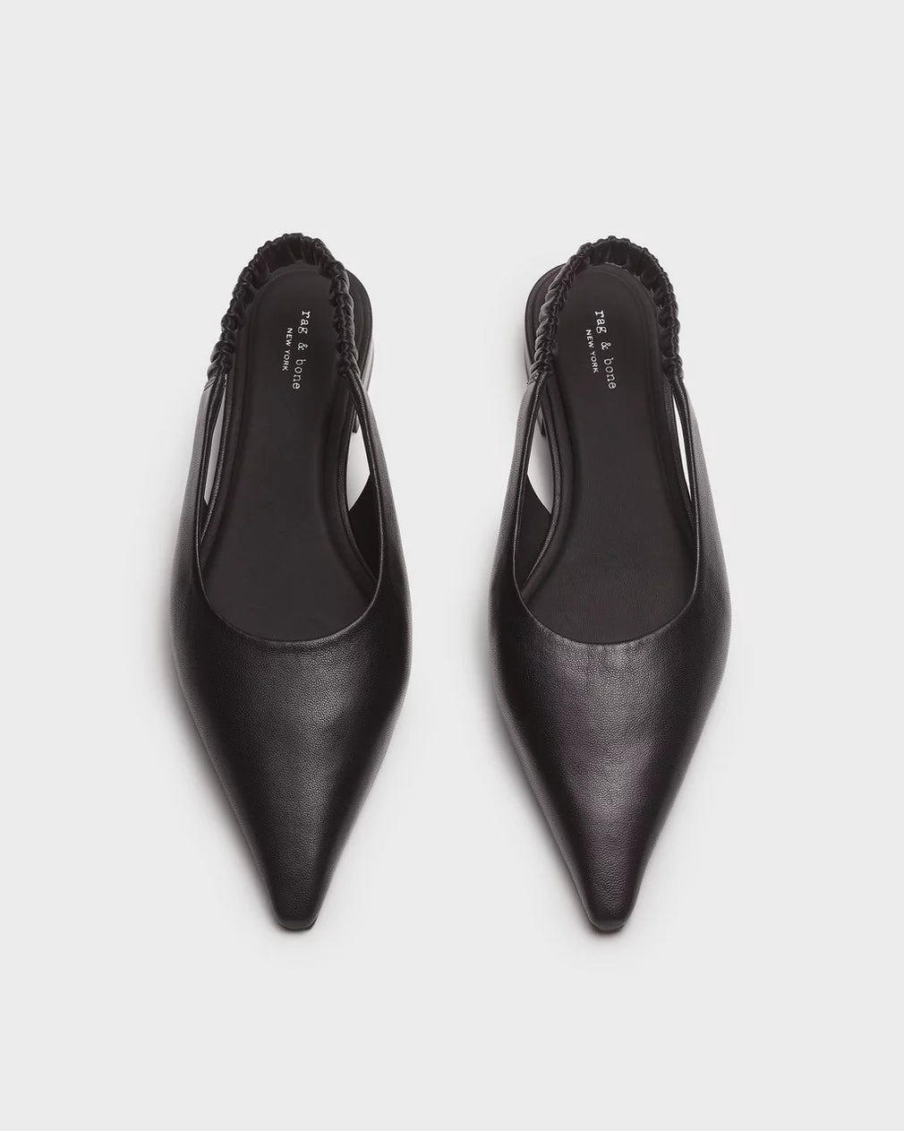 The Rag & Bone mercer slingback flat is a black pointed-toe leather shoe featuring elasticated back bands and a cushioned footbed, shown against a plain white background.