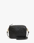 The Clare Vivier Midi Sac S25 is a small black handwoven leather crossbody with gold-tone hardware, an adjustable strap, and a rectangular shape, shown against a plain white background.
