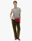 Clare Vivier Midi Sac 26 crossbody bag styled with a striped tee, olive pants, and brown shoes for a casual look.