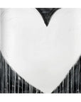 The "Modern Love Hunk of Love 4x4" by Kerri Rosenthal features a large white heart adorned with black accents on a deep black background, enhanced by paint drips that add texture and sophistication. Its abstract and monochromatic style makes it an ideal match for neutral decor.