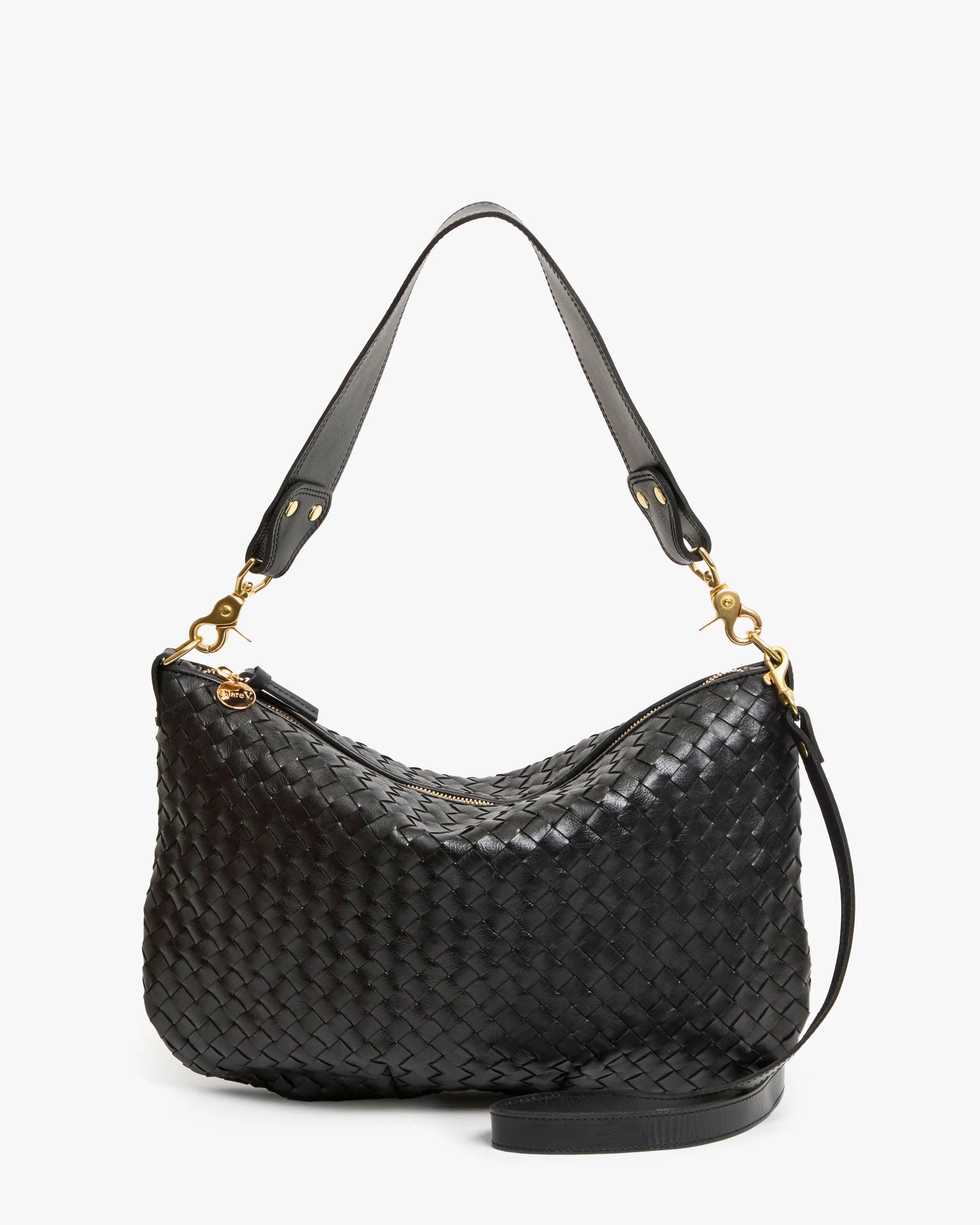 The Clare Vivier Moyen Messenger S25 is a black handwoven leather bag with gold hardware, a short shoulder strap, zippered top, and a detachable crossbody strap for versatile styling.