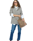 Kerri Rosenthal Nomad Tote carried by woman in plaid blazer and jeans for a modern, confident look.