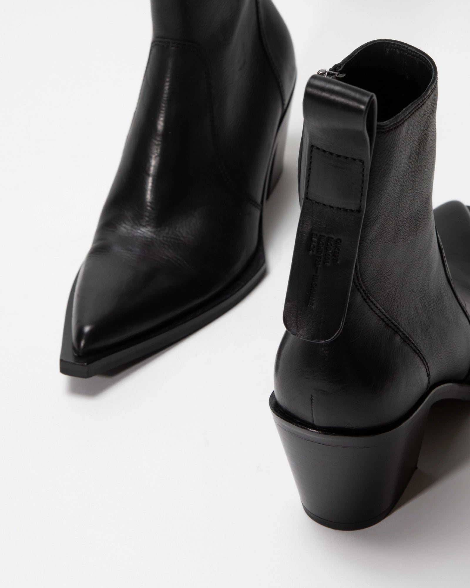 Close-up of the ONCEPT Nashville Boot—women's genuine leather ankle boots with pointed toes, chunky heels, and a stitched pull tab—set against a white background.