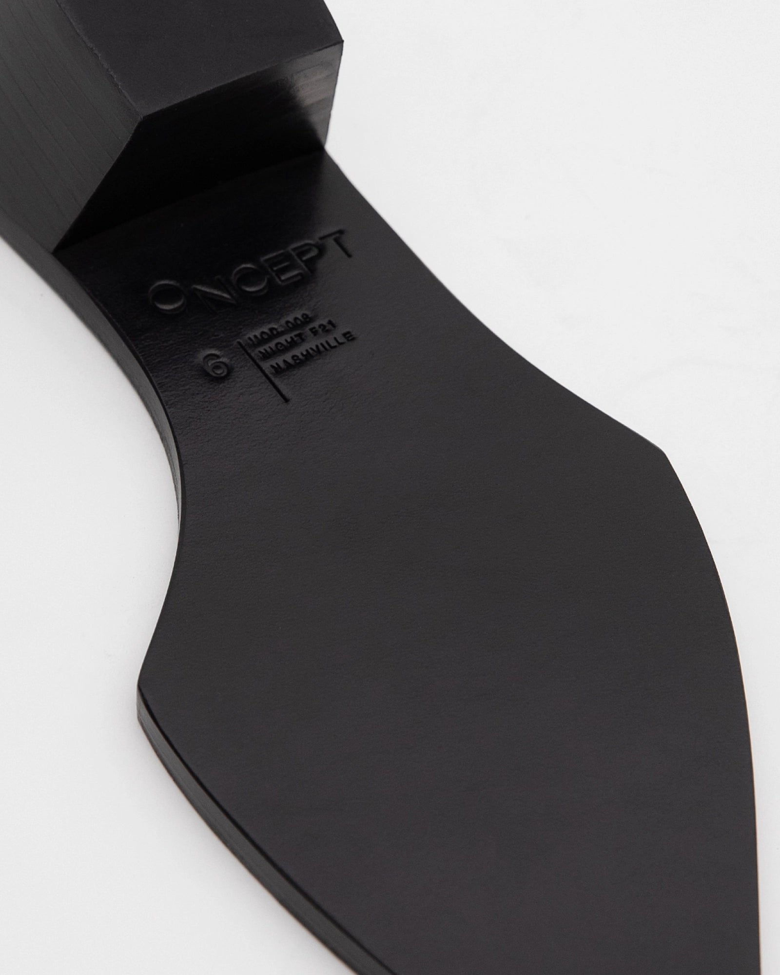 Close-up of the black sole of the Nashville Boot by ONCEPT, size 6, with "ONCEPT" and "MADE IN ITALY" engraved on genuine leather, shown against a white background.