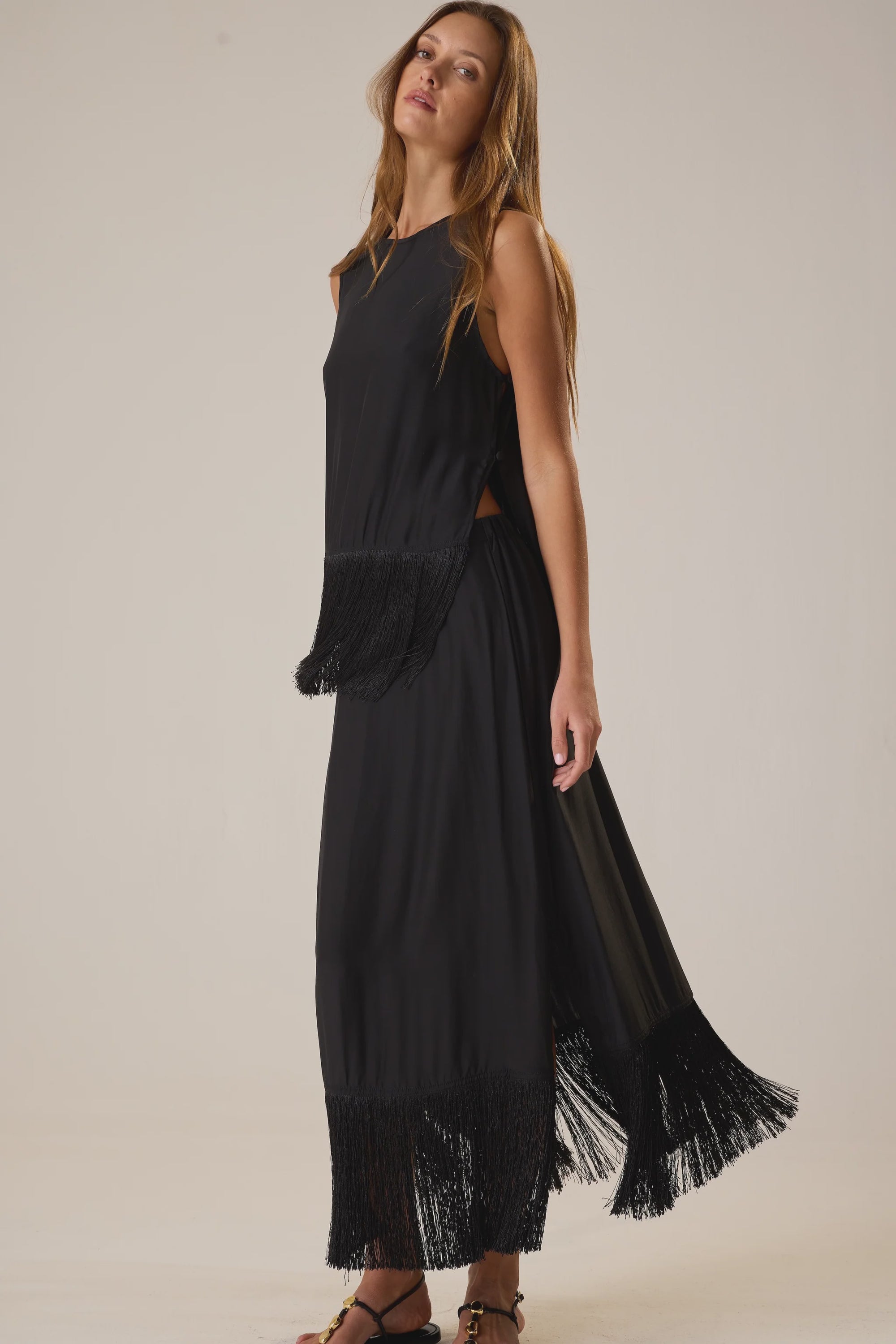 Anita Skirt by Natalie Martin in a minimalist setting; model poses against neutral backdrop looking upward.