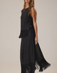 Anita Skirt by Natalie Martin in a minimalist setting; model poses against neutral backdrop looking upward.