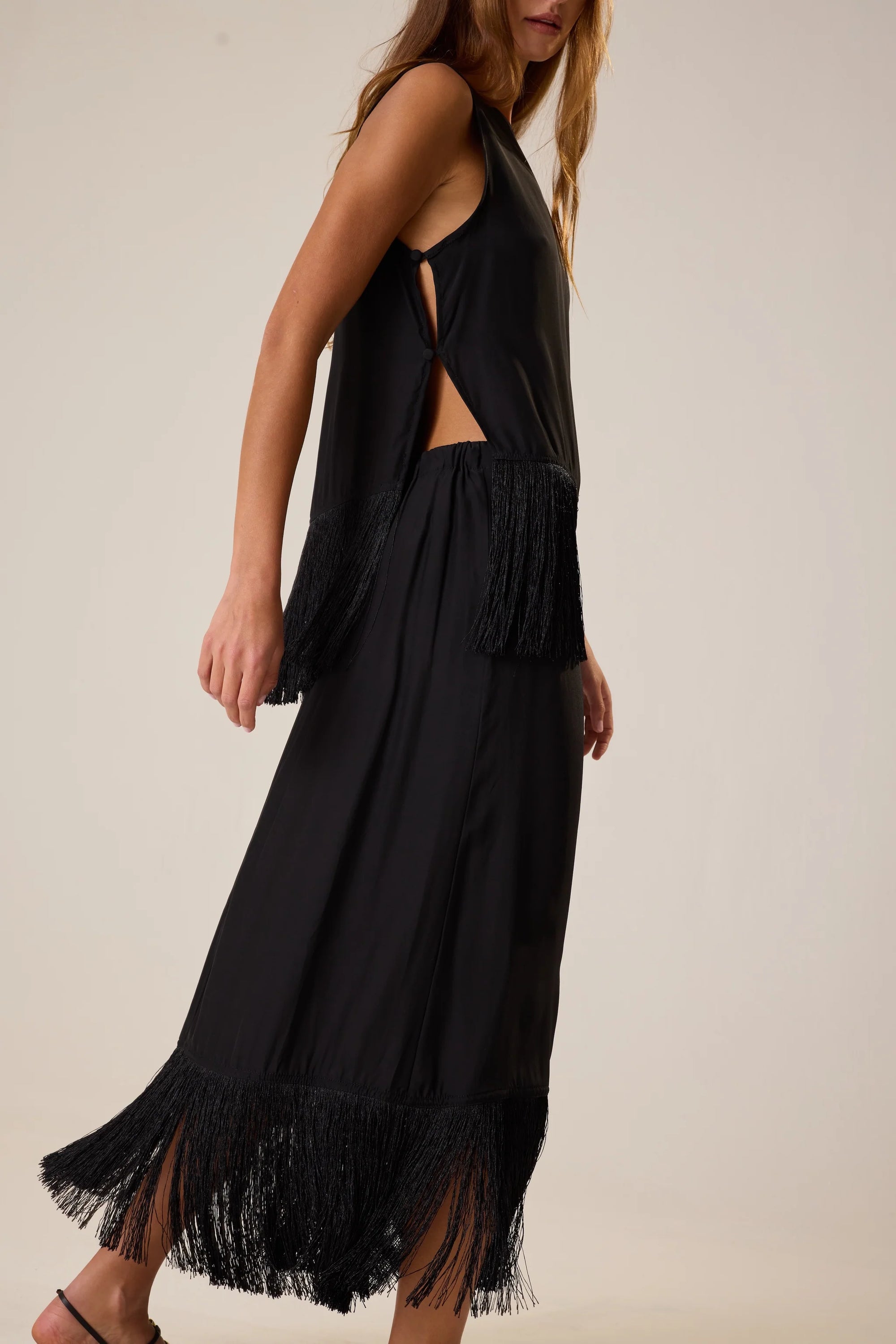Jessie Top by Natalie Martin with fringe hem shown on model against a plain backdrop.