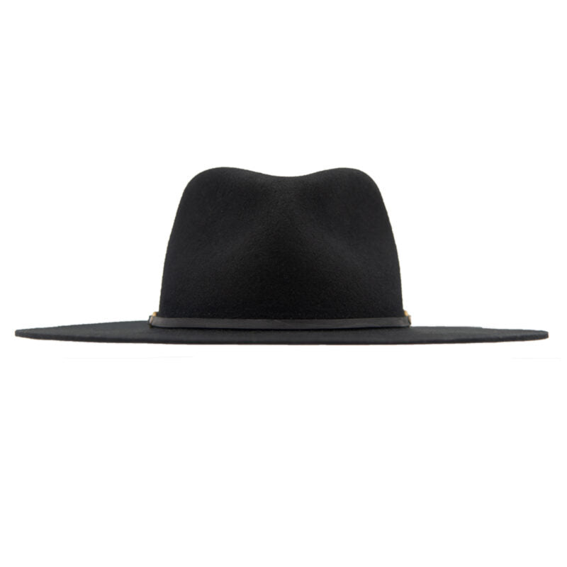 The Maxine Black Fedora by Ninakuru is a stylish wool hat with a wide-brimmed design in black and features a vegetable tanned leather band encircling the crown. Its smooth, felt-like texture and slightly indented top provide both elegance and sun protection, set against a plain white background.