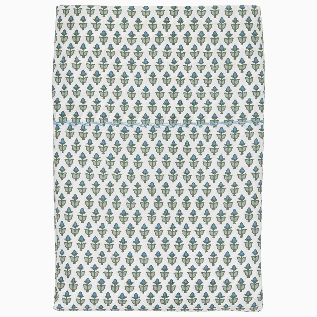 The Cala Fitted Sheet by John Robshaw is crafted from organic cotton percale and features a repeating pattern of small green and blue abstract shapes on a white background.