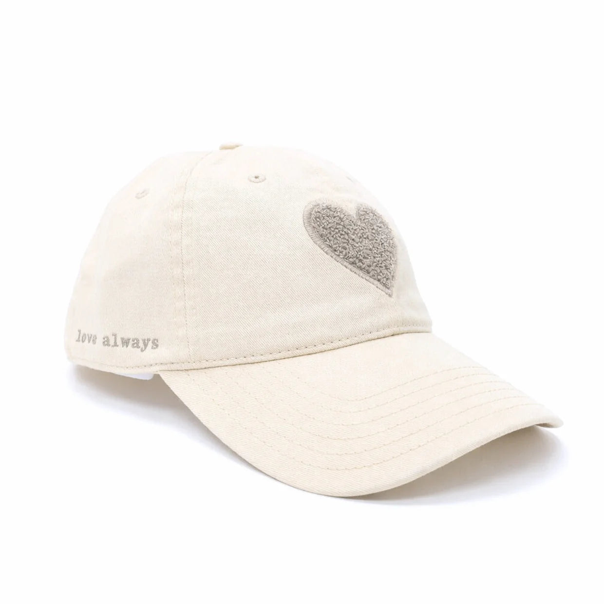 The KR Chenille Heart Hat by Kerri Rosenthal is a beige cotton-twill baseball cap with a textured heart on the front and "love always" embroidered above the brim on the left side.