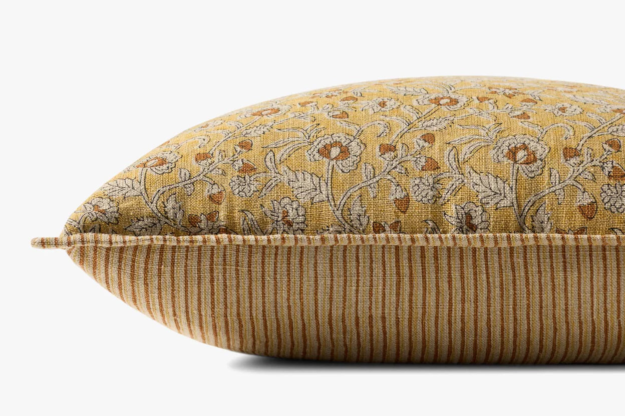 The PLL0164 Pillow 22x22 by Loloi Rugs features a yellow floral linen top, orange and beige vertical striped sides, and a hidden flap zipper, shown close-up against a plain white background.