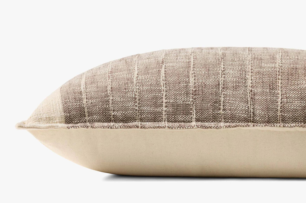 A close-up side view of the Loloi Rugs PLL0183 Brown/Ivory Pillow 16x26, featuring textured brown and ivory striped cotton on top, smooth solid beige on the bottom, and a subtle Loloi logo tag.