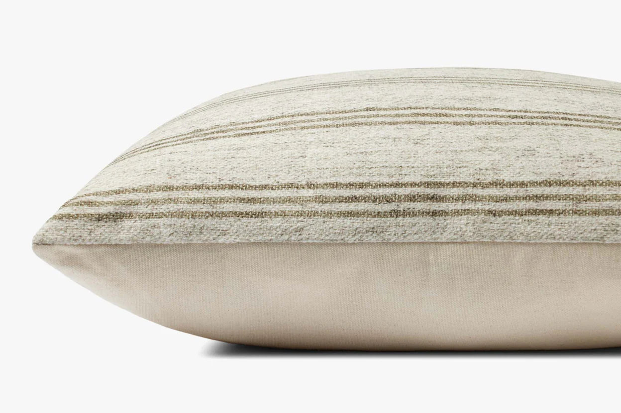 A close-up side view of the Loloi Rugs PAL0040 Zephyr Ivory throw pillow, featuring soft polyester fabric with subtle horizontal light brown and cream stripes, a plush knife edge, and set against a plain white background.