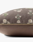 A close-up side view of the Loloi Rugs Poise Mauve Pillow 20x20 shows its brown base, floral white and green pattern, and hidden flap zipper.