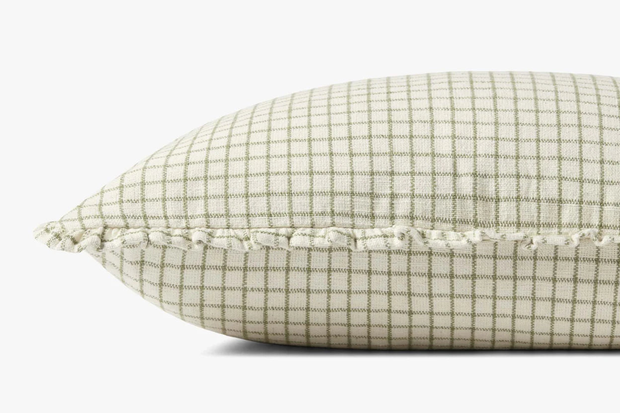 A close-up side view of the Loloi Rugs PCJ0012 Ivory Moss pillow, showing its green and white checkered pattern, hidden zipper, and ruffled fringe edge, set against a plain white background.