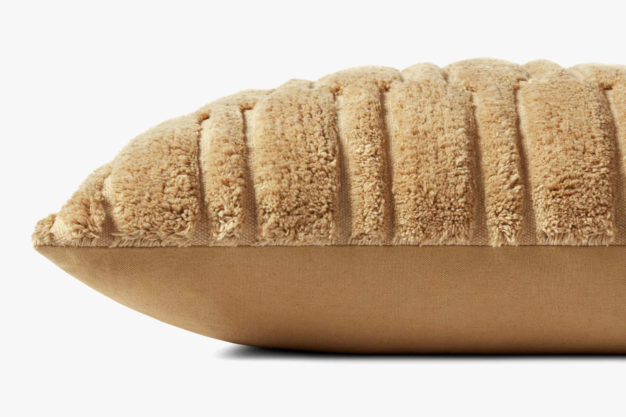 A close-up side view of the Loloi Rugs Arabella Wheat Pillow 16x26” shows its ribbed, fuzzy tan fabric top and smooth solid tan bottom, plus a hidden flap zipper, all set against a plain white background.