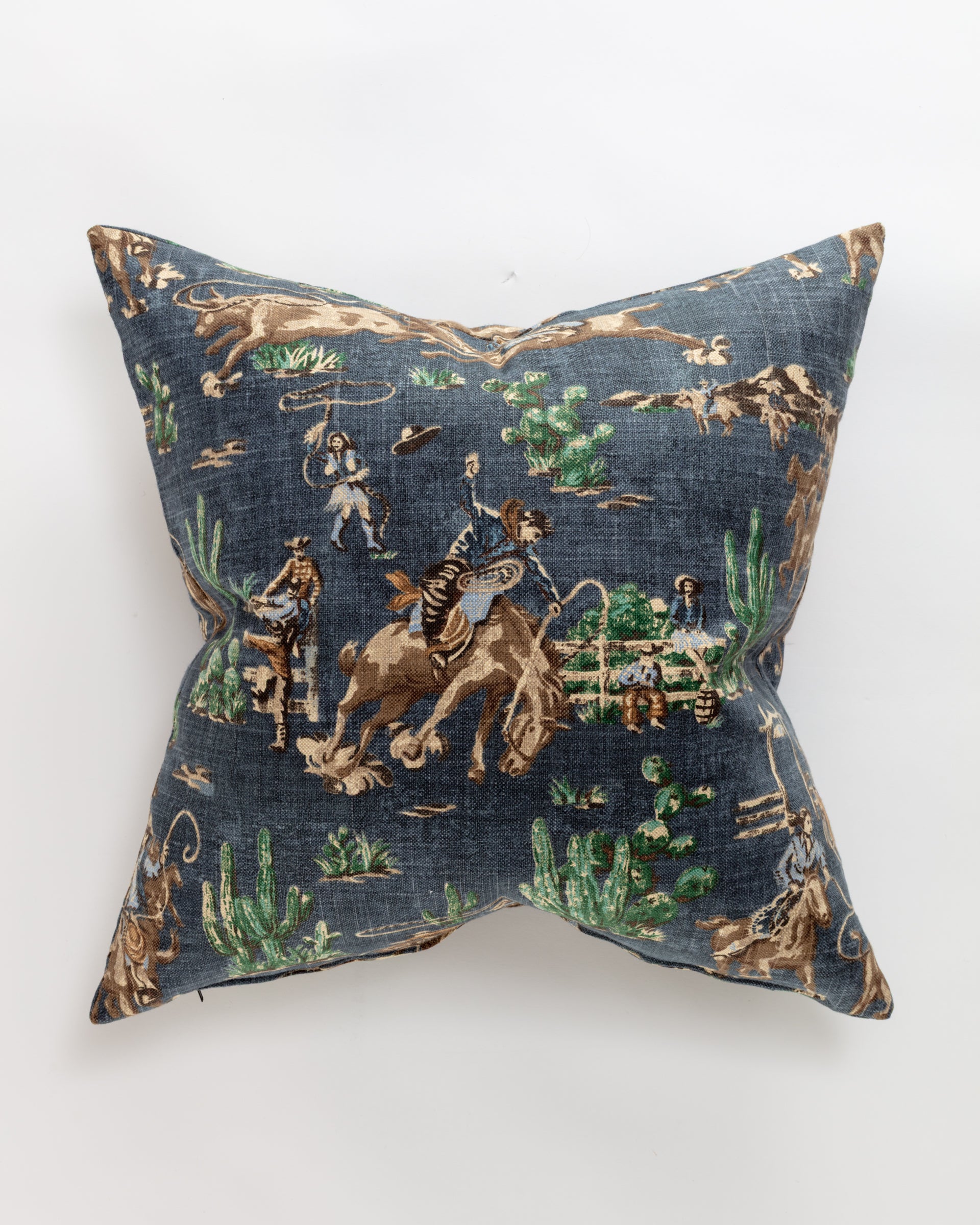 The Pindler Custom 2 Pillow 28x28 features a luxurious dark blue square design with a vintage-style cowboy pattern, including cowboys on horseback, cacti, and lassos in brown, green, and beige tones. It includes a plush insert and evokes a charming southwestern theme ideal for euro pillows.