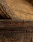 Close-up of an intricately crafted Oval Wood Bucket 10 from an Indus Design Imports bungalow showing detailed joinery and natural wood grain textures.