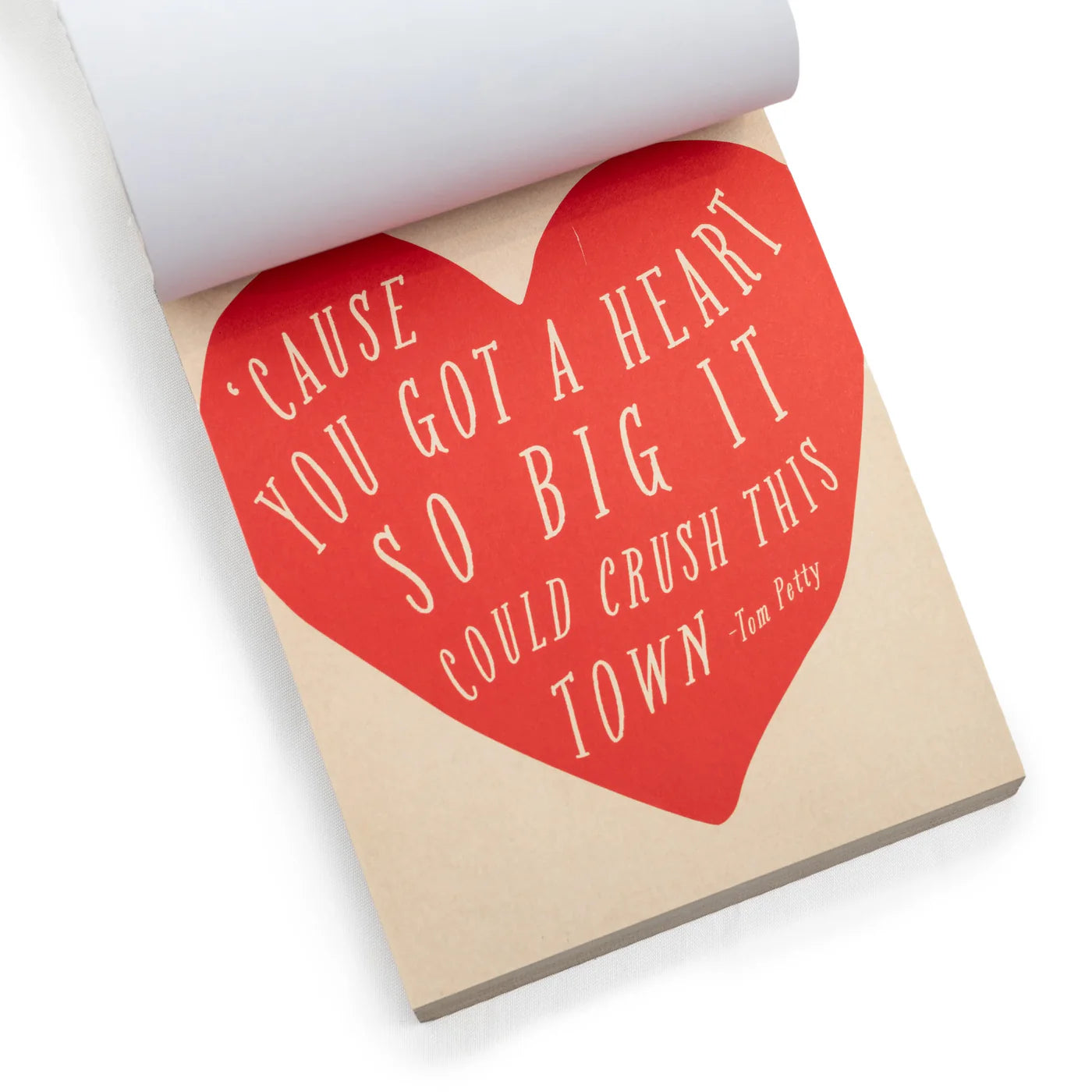 The "150 Love Letters for Your Hunny Bunny" notepad by Sugarboo Designs showcases a red heart with Tom Petty's quote: "'Cause you got a heart so big it could crush this town." Ideal for soul-enlightening love letters that brighten any day.