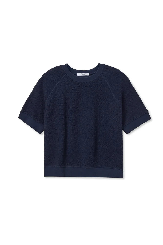 The Kennedy SS Crew Sweatshirt by Perfectwhitetee is a navy blue terry cloth short sleeve top with a relaxed fit, ribbed cuffs, neckline, and hem, shown on a white background.