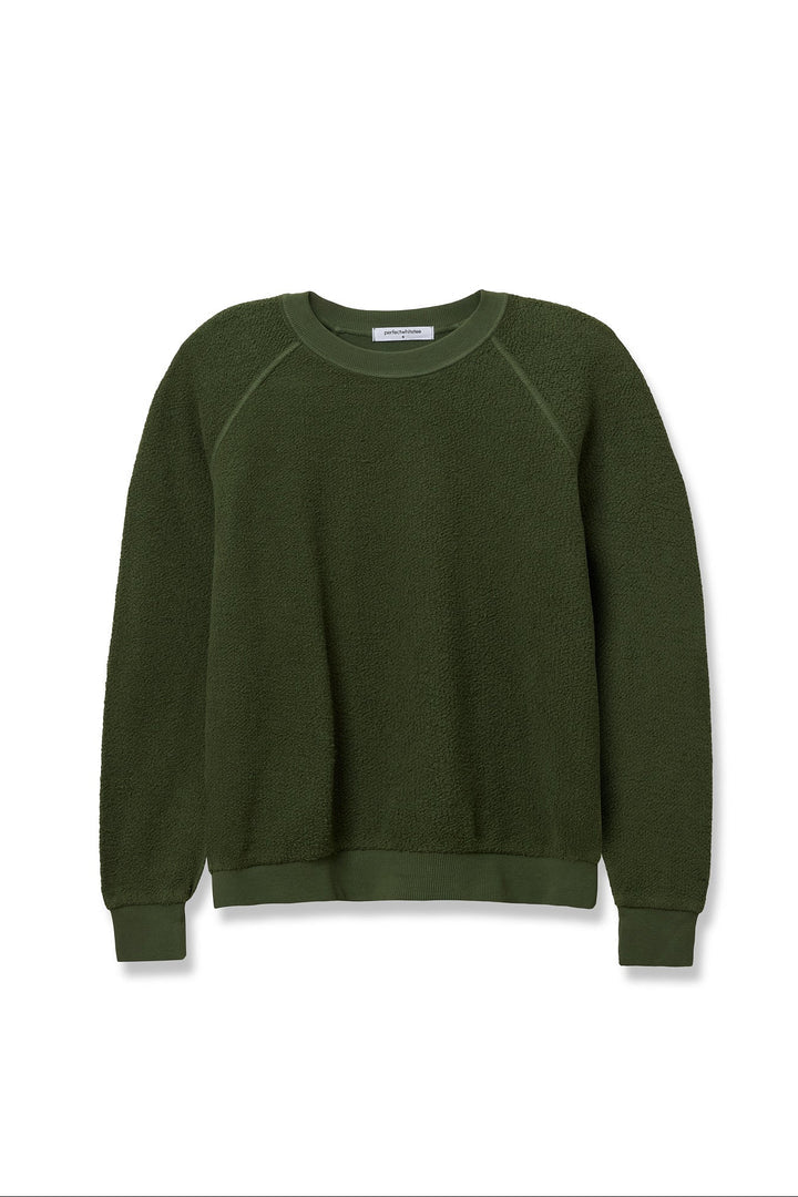 The Ziggy Reverse LS Sweatshirt by Perfectwhitetee is a dark green crewneck made from inside out cotton fleece with bracelet-length sleeves, ribbed cuffs, hem, and neckline, displayed on a white background.