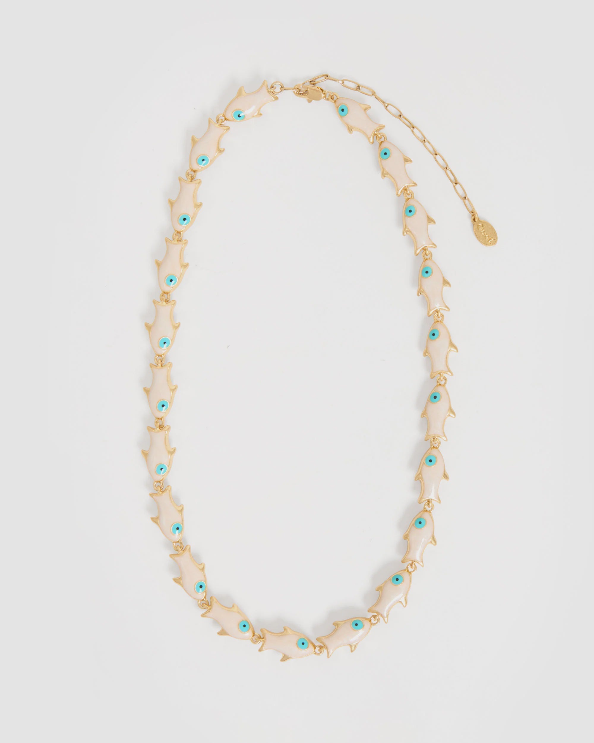 The Pearl Sardine Necklace by Clare Vivier features gold plated brass with enamel fish-shaped charms, each with a turquoise blue eye, evenly spaced on the chain and finished with an adjustable clasp and round tag.