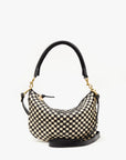 Introducing the Clare Vivier Petit Moyen Woven Checker, a small handbag with a distinctive black and beige-checkered pattern. This elegantly curved bag features a black leather top handle secured with gold hardware clasps, adding a touch of sophistication. The handwoven leather bottom enhances durability without compromising on style.