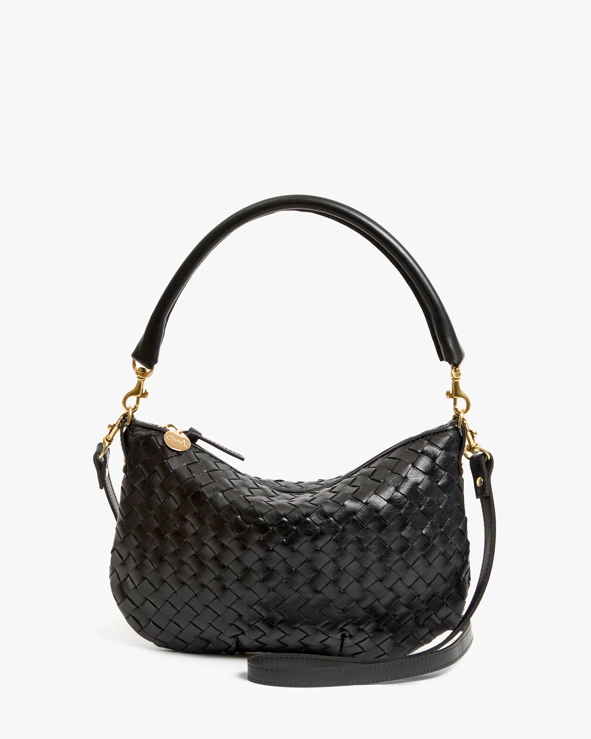 The Clare Vivier Petit Moyen Messenger S25 is a black handwoven leather mini messenger bag with a curved top handle, detachable gold hardware, and adjustable crossbody straps, shown against a plain white background.
