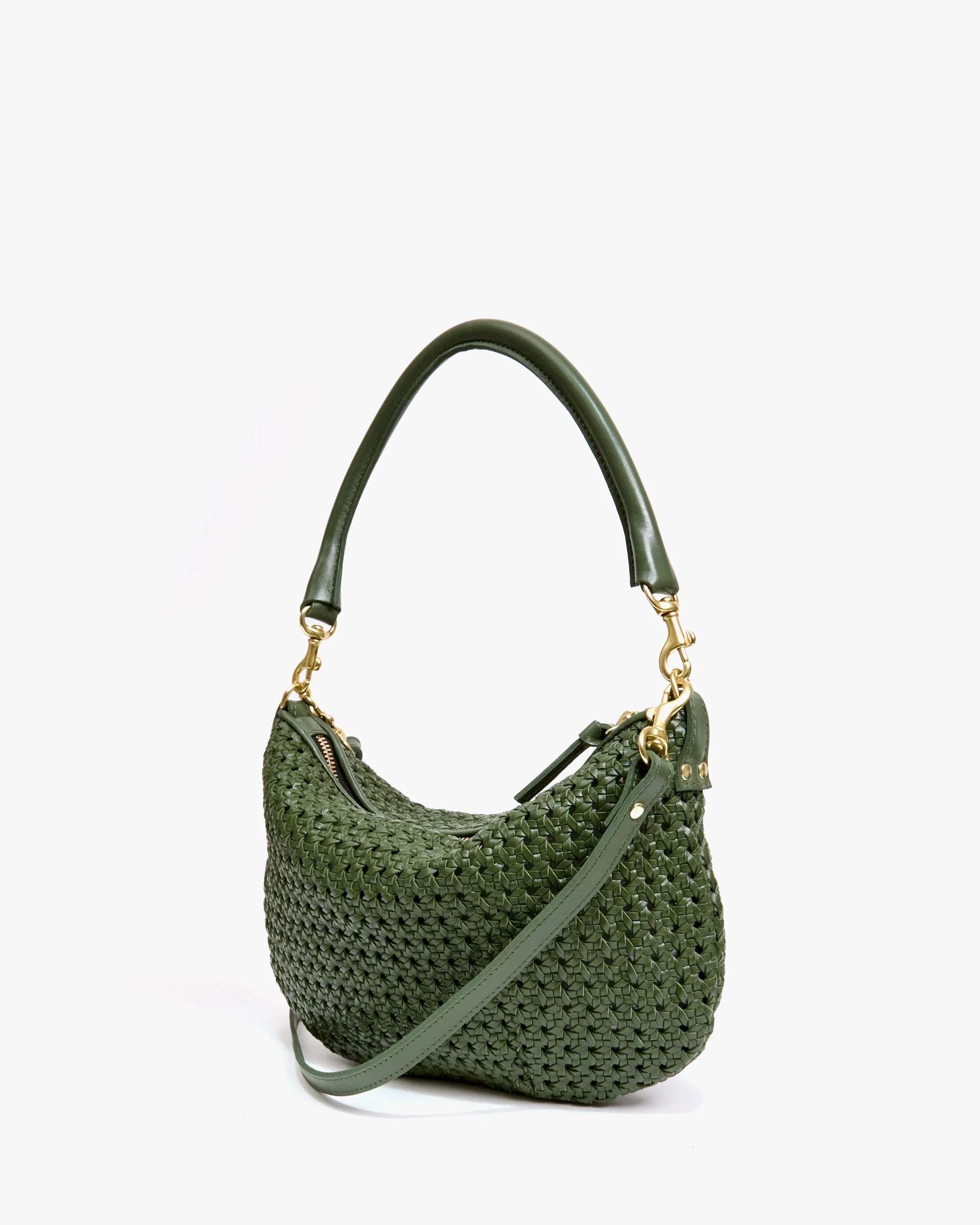 The Petit Moyen Messenger S25 by Clare Vivier is a green handwoven leather mini bag with a short handle, long crossbody straps, gold hardware, and a basket-like texture, displayed against a plain white background.