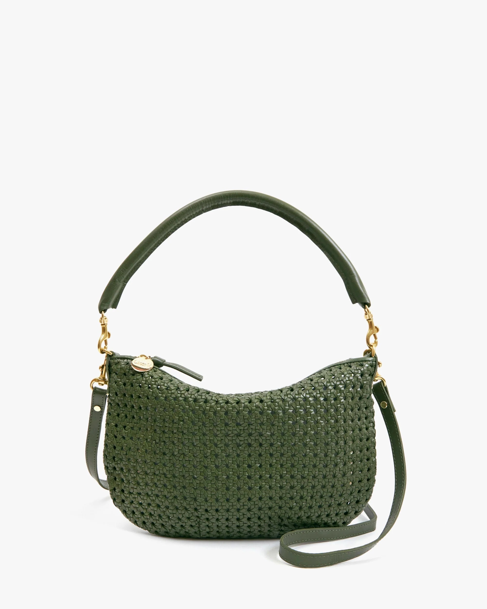 The Clare Vivier Petit Moyen Messenger S25 is a green handwoven leather mini bag with a curved top handle, detachable crossbody straps, gold-tone hardware, and a small round charm by the zipper.
