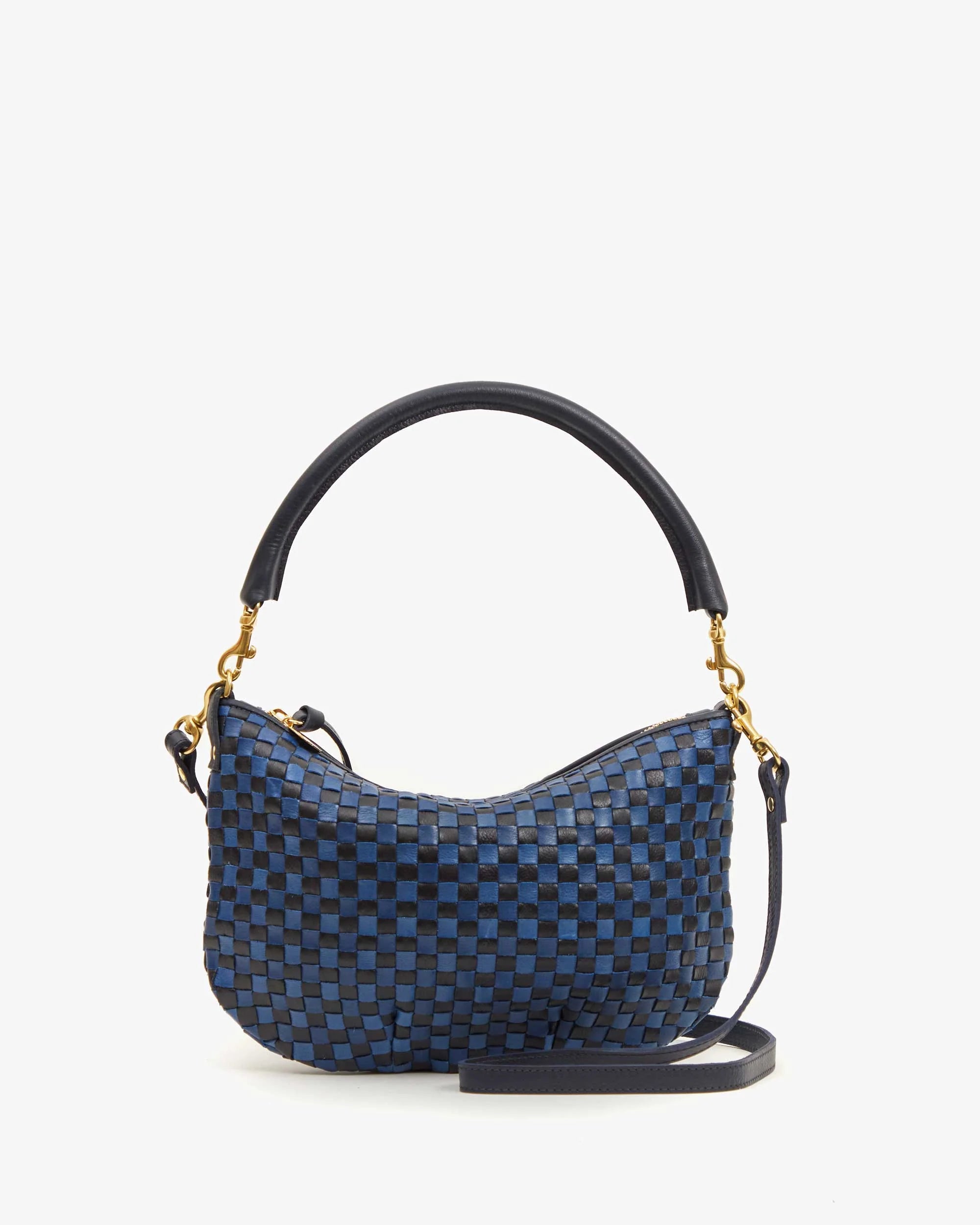 Introducing the Clare Vivier &quot;Petite Moyen S24,&quot; a chic mini messenger handbag adorned with a blue and black checkered pattern and elegantly finished with a curved black handle. It boasts gold-tone hardware, handwoven leather accents, and detachable crossbody straps, all beautifully presented against a plain white background.