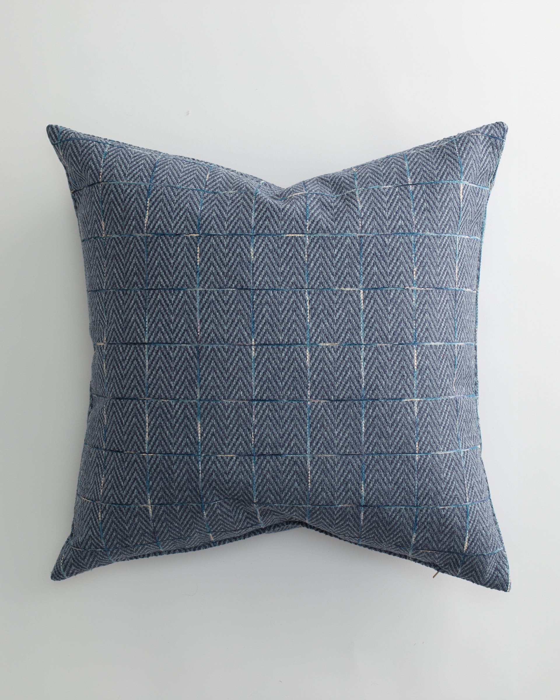 The WADLEY 26x26 Pillow by Pindler features a rectangular blue design with a subtle herringbone texture and fine light blue grid lines, shown on a white background—an exclusive choice for luxurious throw pillows.