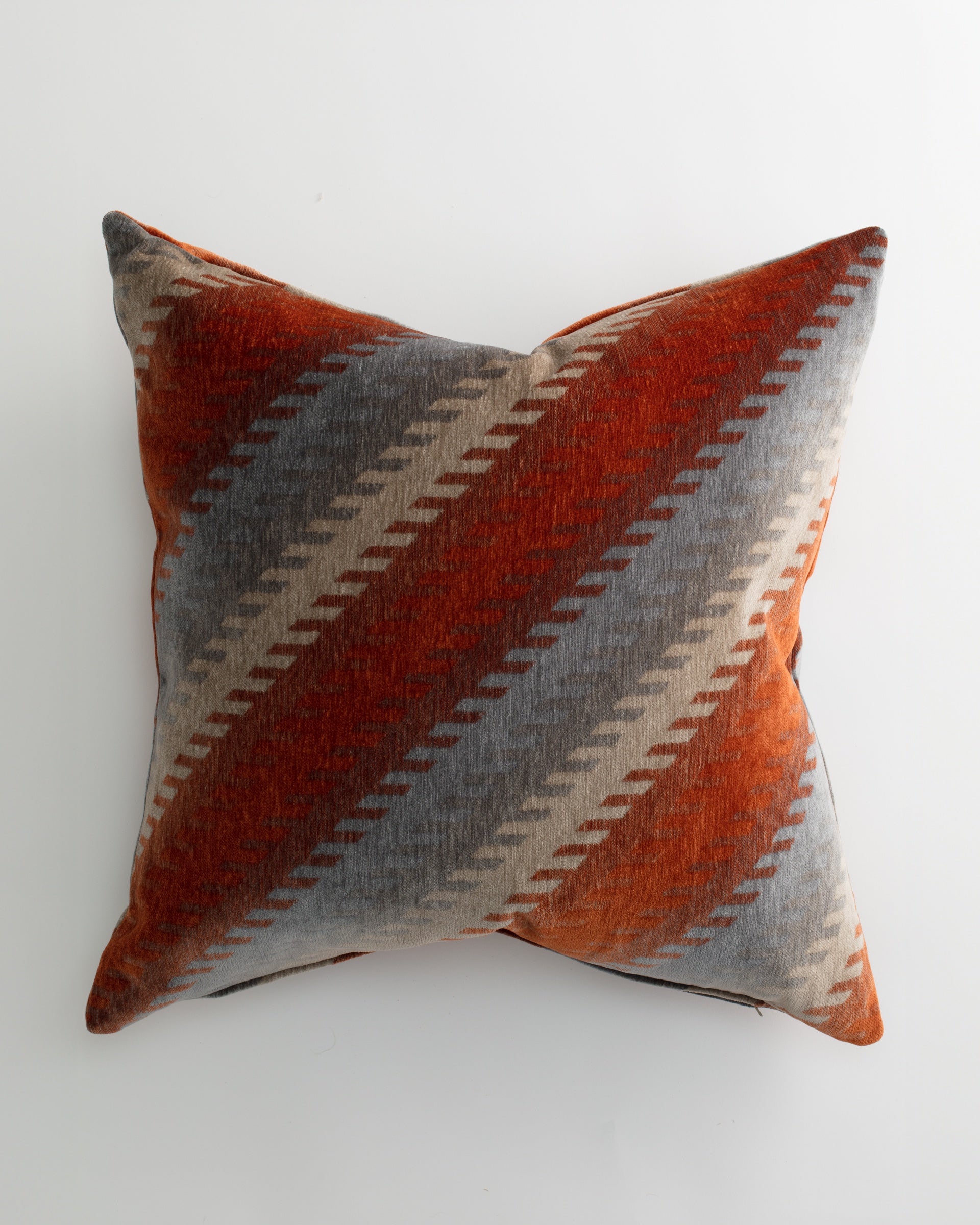 The Pindler BRYCE 26x26 Pillow showcases a plush down insert and a diagonal stripe pattern in rust orange, gray, and beige on white for a luxurious accent.