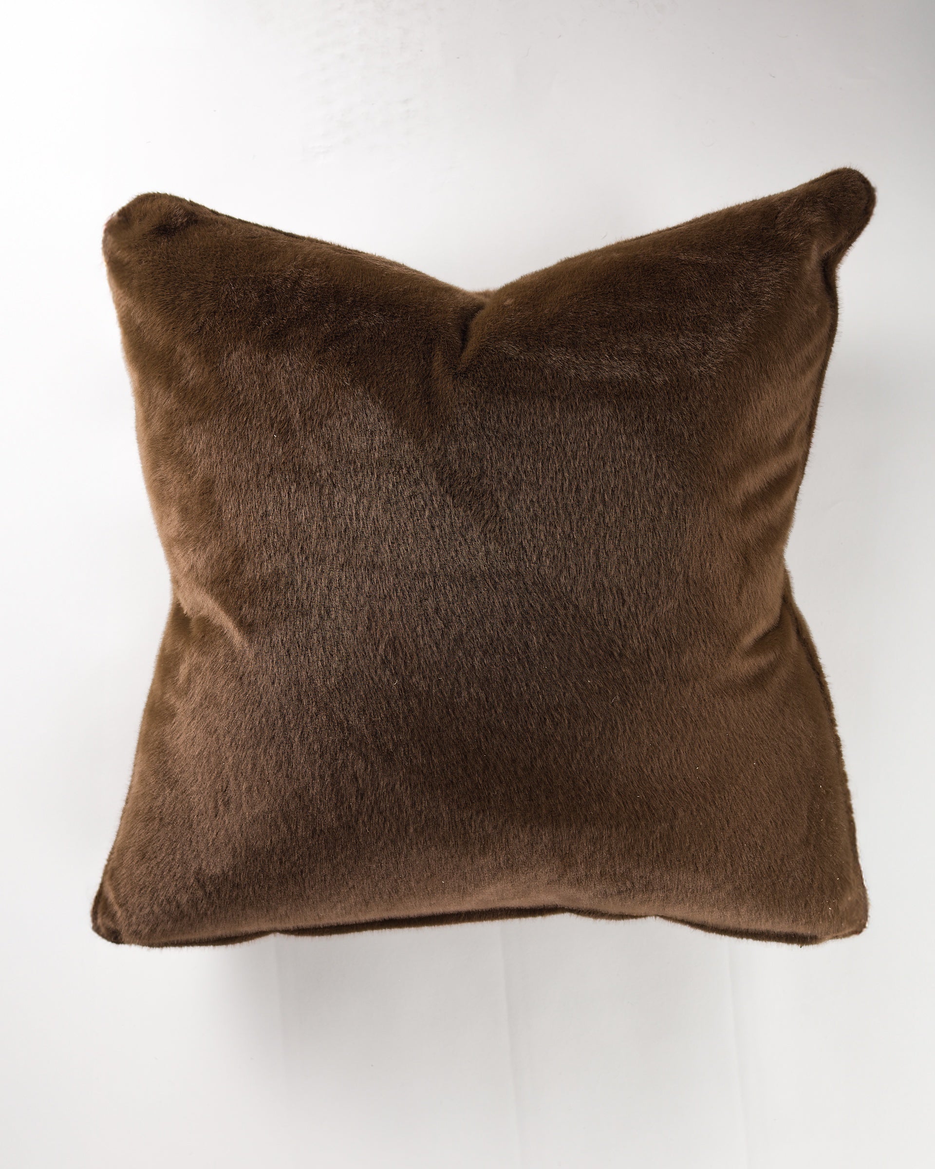 The Gabby Mink Chocolate Gr-3 Pillow 26x26 features a soft, square, velvety texture in brown with a quality insert, displayed against a white background for a touch of luxury.