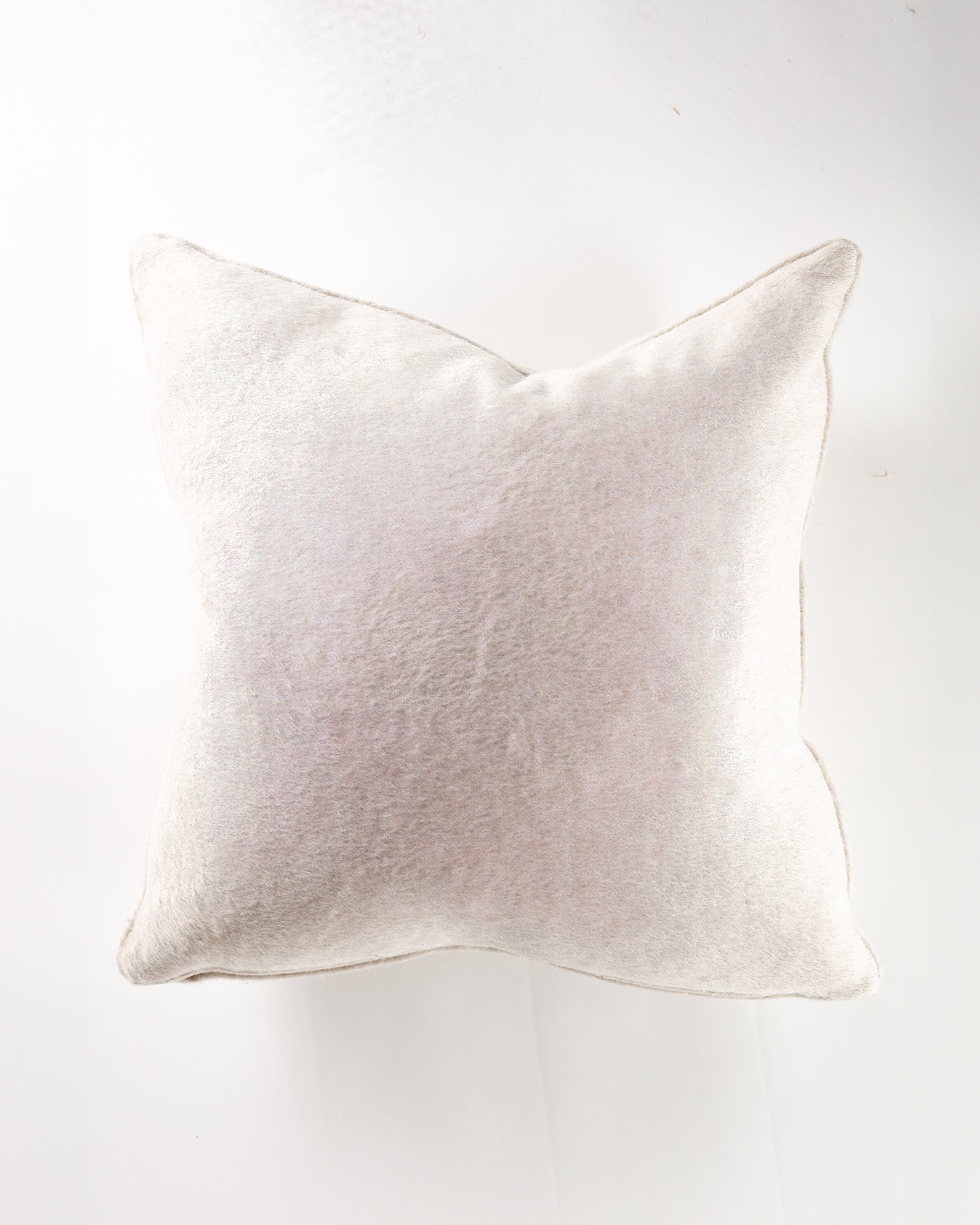 The Gabby Paca Linen Gr-10 Pillow 26x26, shown from above against a white background, features a soft, light beige velvety finish—an elegant and luxurious addition to your pillow collection.