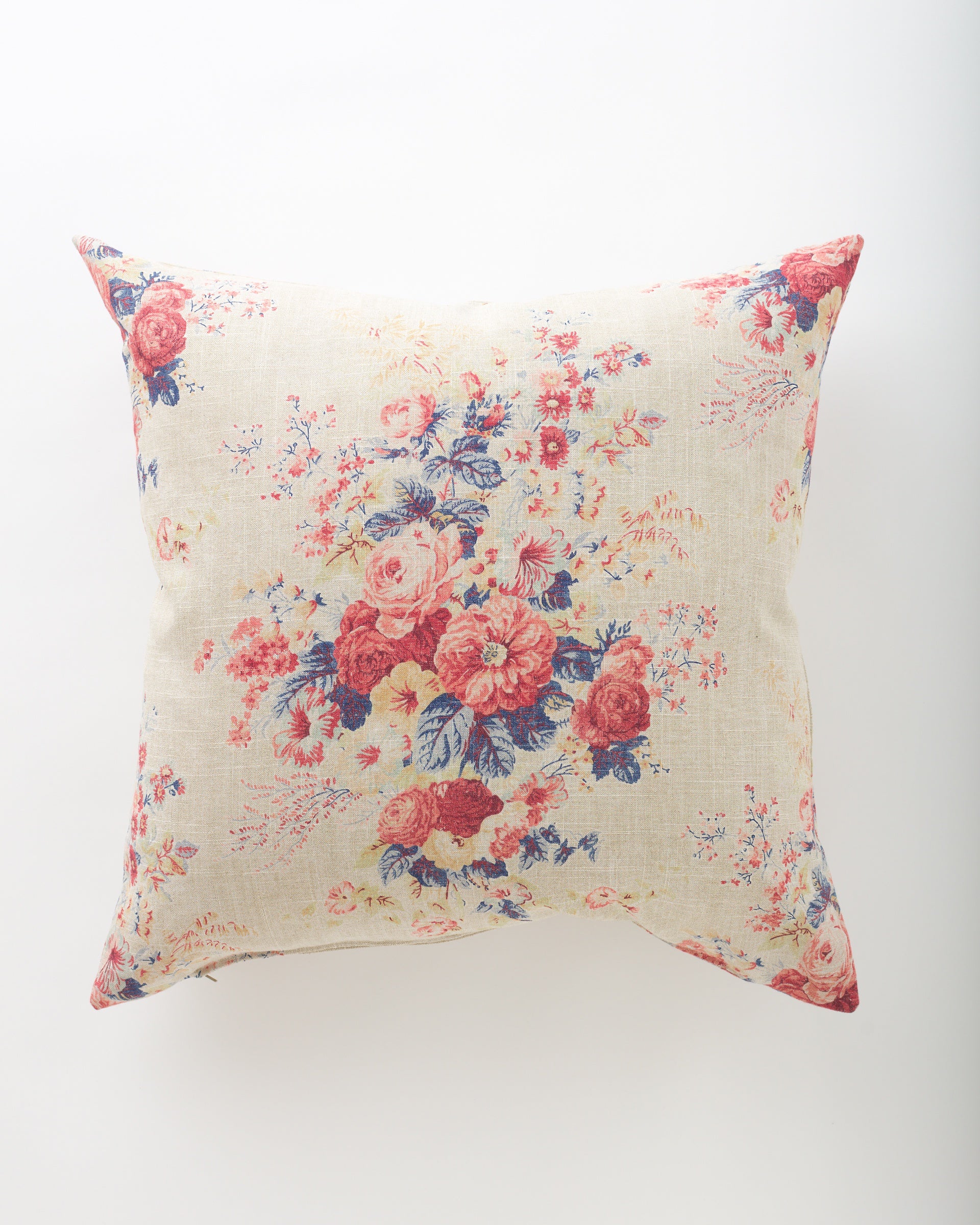 The Archer 26x26 by Pindler is a square throw pillow with a light beige base and vintage-style floral pattern in red, pink, and blue with green leaves. It features a plush insert for extra comfort, perfect for luxurious pillows.