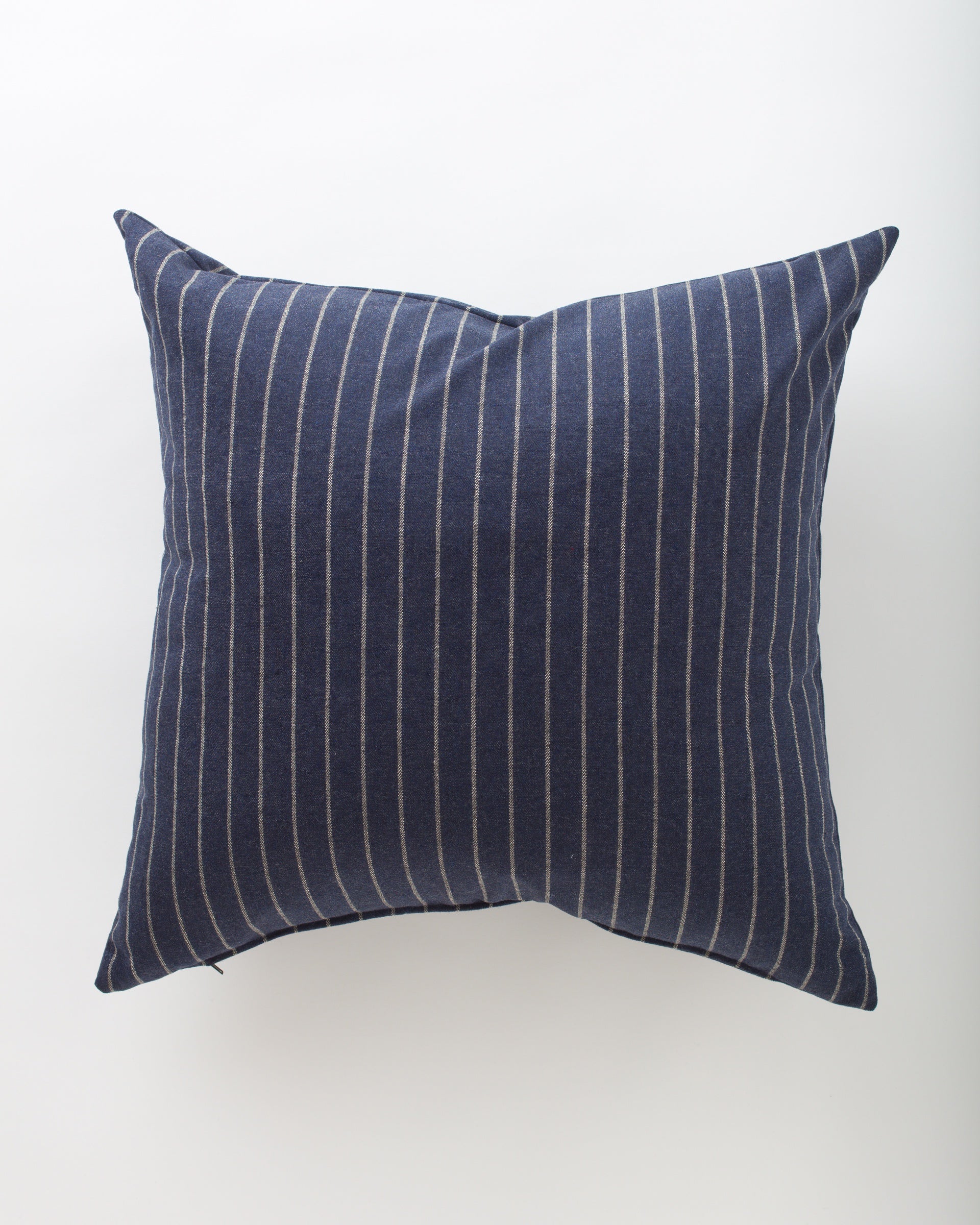The Orla 26x26 by Pindler features a dark blue background with thin, evenly spaced vertical white stripes—an elegant choice for elevating your euro pillows collection.