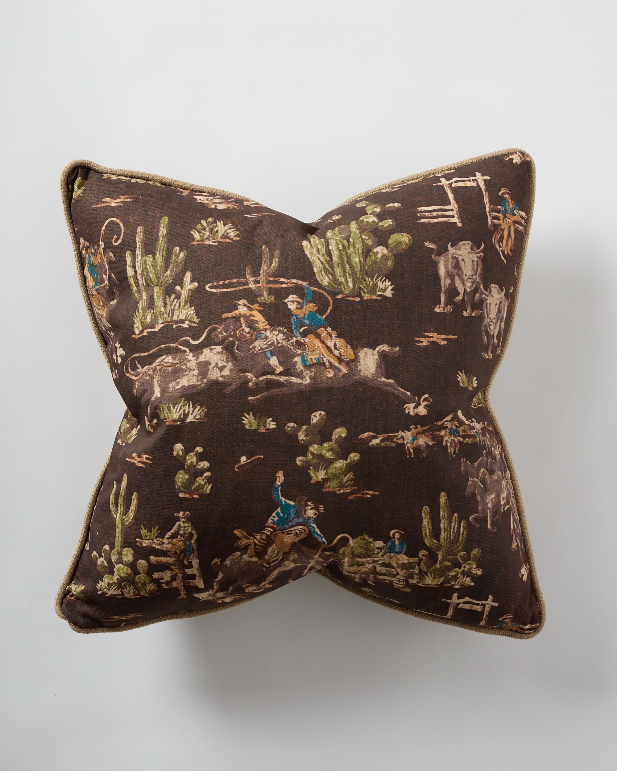 The Design Legacy Brown Cowboy Jute 26x26 pillow features a chocolate brown jute fabric with a vintage cowboy and horse print, including cacti, perfect for adding rustic Western charm to your decor.