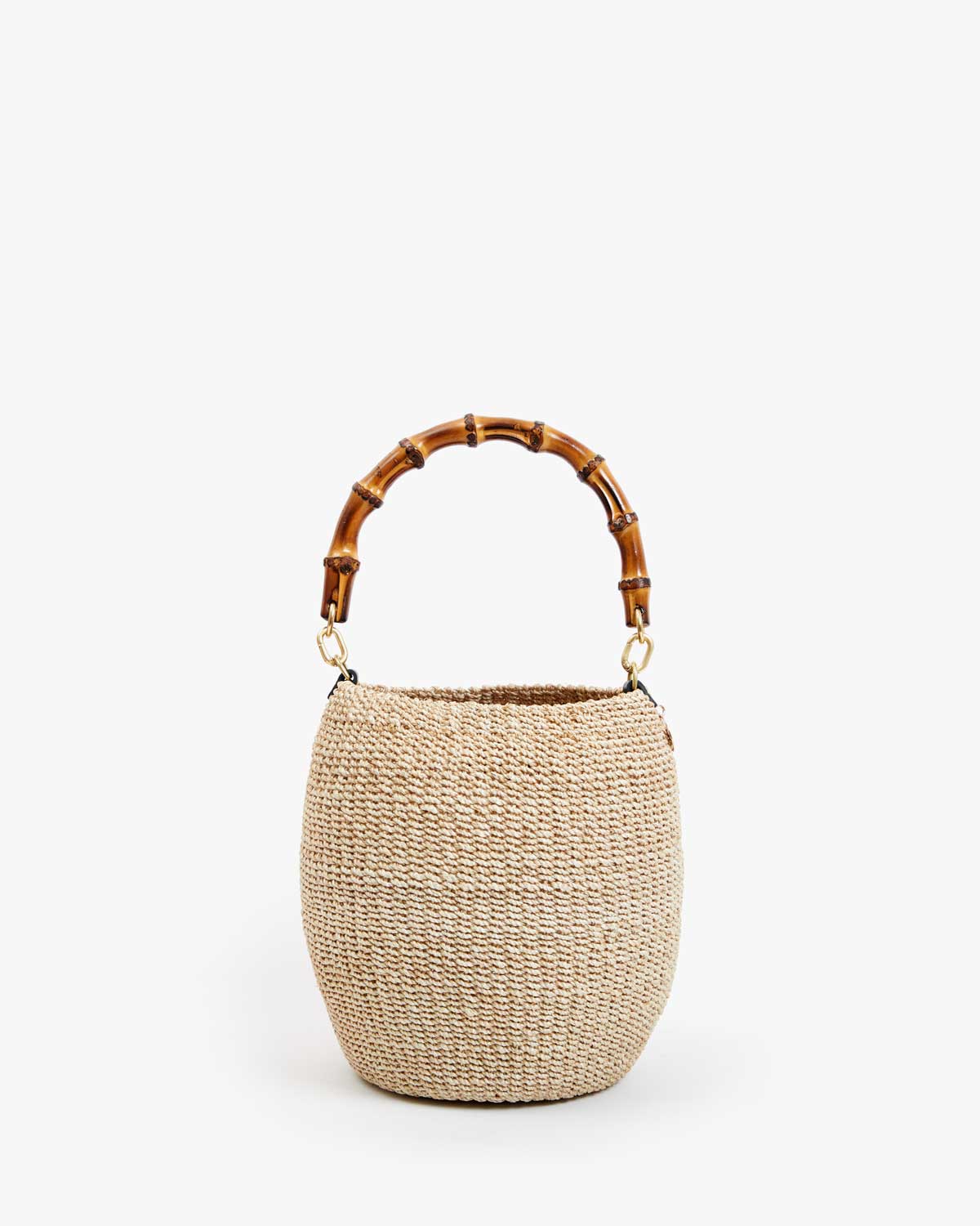 The Pot de Miel basket bag by Clare Vivier, featuring a woven straw texture and rounded shape with a bamboo handle, is showcased against a plain white background.