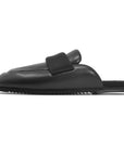The Roam Puffy Loafer is a black, backless slip-on mule with a thick cushioned upper, memory foam insoles, rounded toe, and flat sole, shown in side profile on a plain white background.