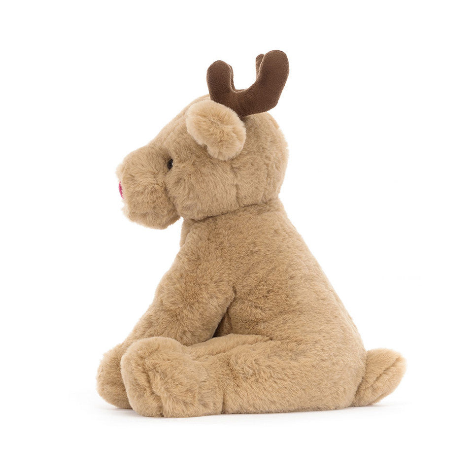The Romi Reindeer plush by Jelly Cat Inc. features light brown fur, dark brown antlers, and a pink nose. Sitting upright on a white background, this soft and cuddly toy adds festive charm to any room for the holiday season.