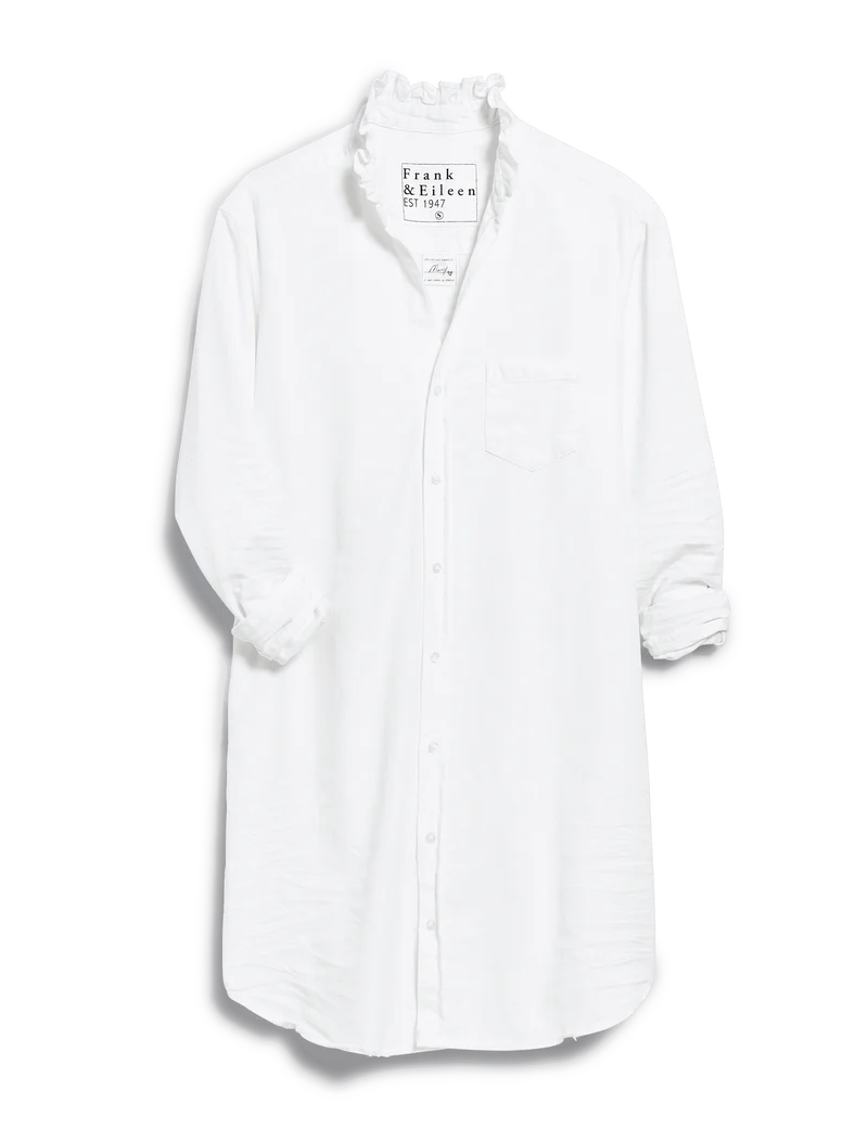 The RUFFLE MARY Classic Shirt Dress F25 by Frank & Eileen is a white long-sleeve shirtdress with a ruffle collar, button-down front, rolled-up sleeves, and chest pocket, shown against a plain background.