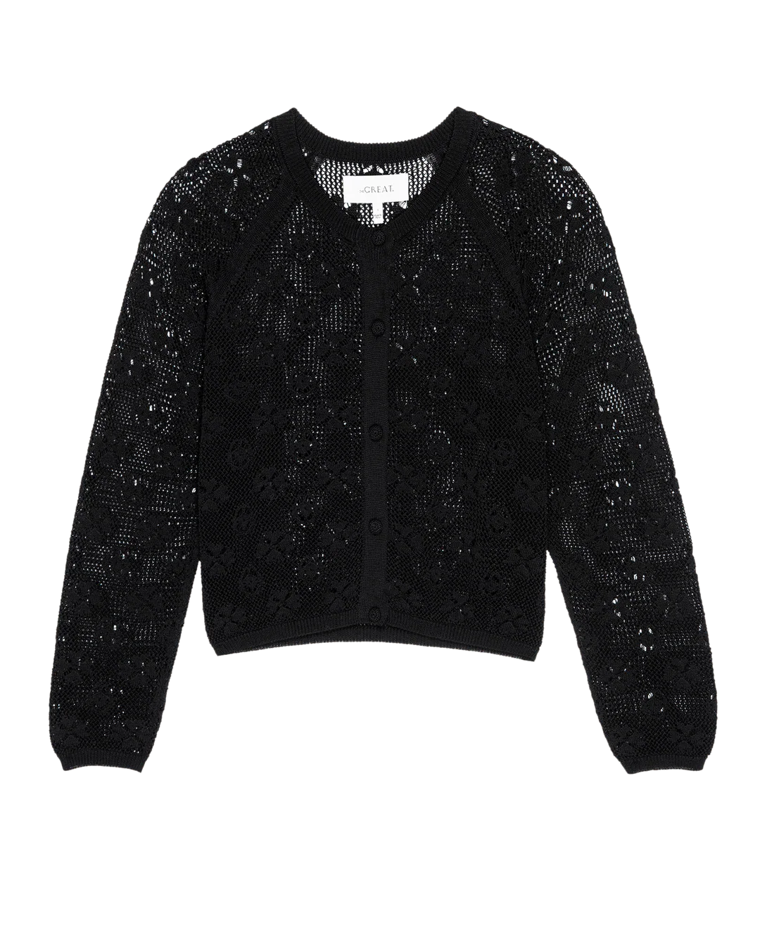 The Great Inc. Crochet Cardigan is a black, long-sleeve cotton piece with a V-neck, front buttons, and a delicate openwork floral pattern that adds vintage crochet charm.