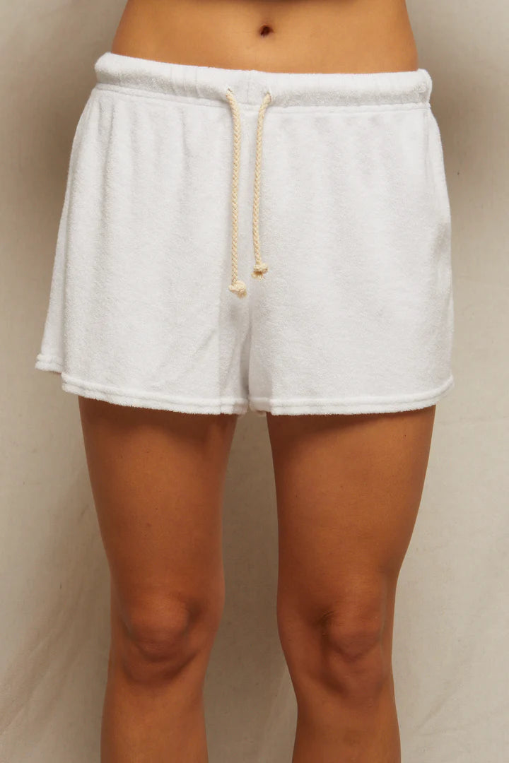 A person wears Perfectwhitetee's Summer Loop Terry Sweat Shorts—white with a beige drawstring—against a plain, light background. The photo is cropped from waist to mid-thigh.