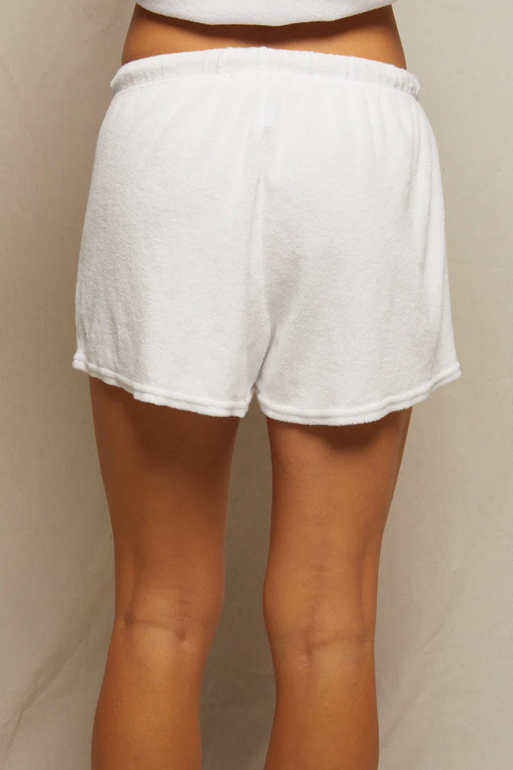 A person is shown from the waist down wearing Perfectwhitetee&#39;s Summer Loop Terry Sweat Shorts with an elastic waistband and a short length, offering luxurious loungewear comfort against a neutral background.