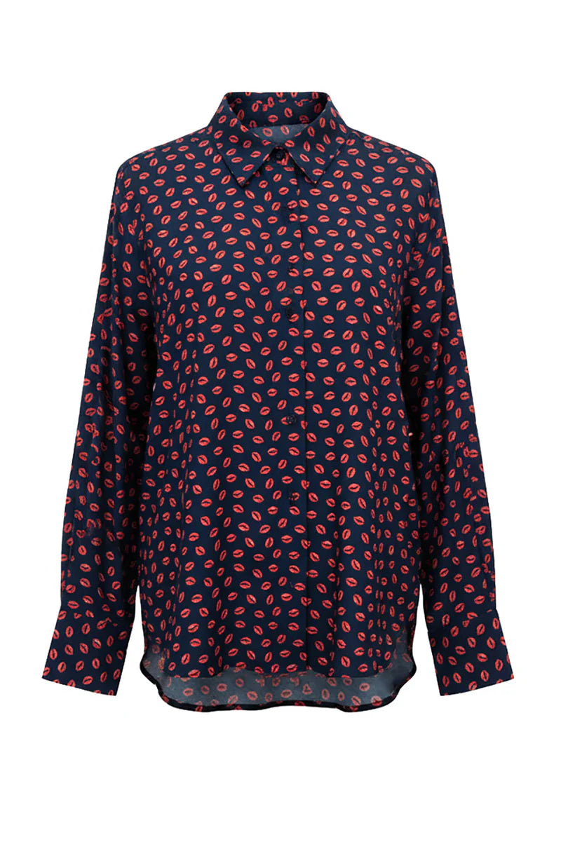 The Many Kisses Shirt by Le Superbe is a lightweight, oversized navy button-up with an all-over red lip print. It features long sleeves, a classic collar, and a loose, casual fit.